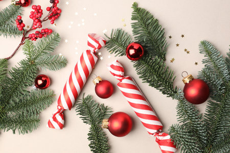 Fir tree branches, candies and Christmas decor on light background, flat layの写真素材