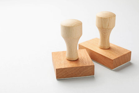 Two wooden stamps on white background, closeup. Space for textの写真素材