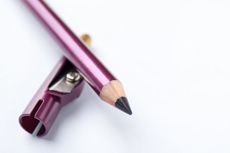 Purple eyeliner and sharpener on white background, closeup.の写真素材