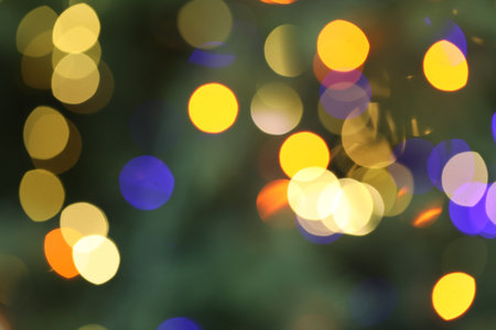 Beautiful blurred Christmas lights on color background, closeup. Bokeh effectの写真素材