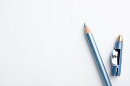 Light blue eyeliner and sharpener on white background, top view. Space for textの写真素材