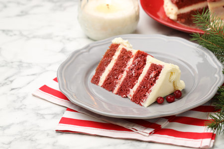 Slice of tasty cake with cranberries served on white marble table, closeup. Christmas dessert