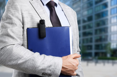 Man with spy camera near building outdoors, closeupの写真素材