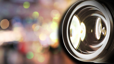 Camera lens against blurred background, bokeh lights. Banner design