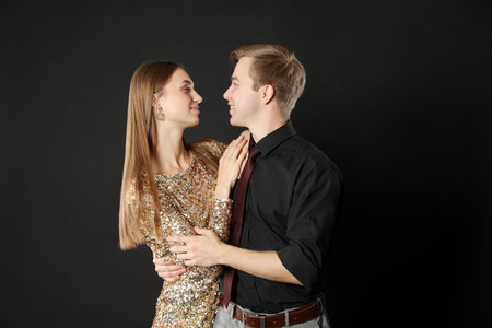 Lovely couple on black background. Romantic date