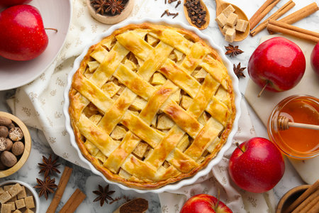 Tasty homemade apple pie and ingredients on white marble table, flat layの写真素材