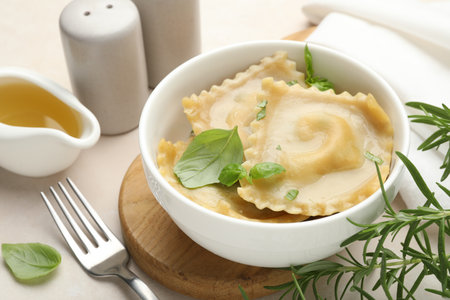 Delicious ravioli with basil served on light table, closeupの写真素材