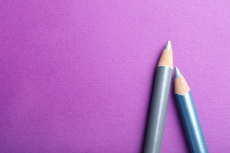 Different pencils on purple background, top view. Space for textの写真素材