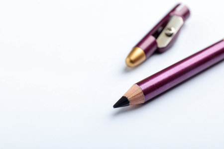 Purple pencil and sharpener on white background, closeup. Space for textの写真素材
