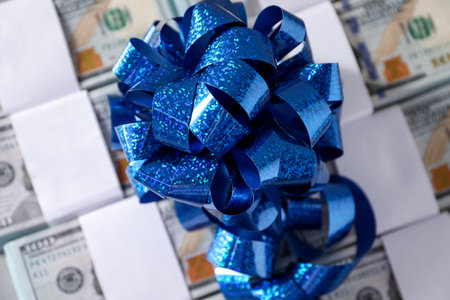 Dollar banknotes with bow on light background, closeup