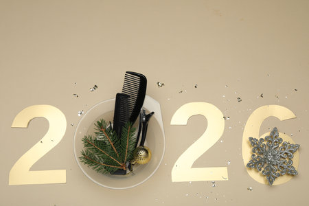Golden numbers 2026, hairdresser's tools and Christmas decor on beige background, flat layの写真素材