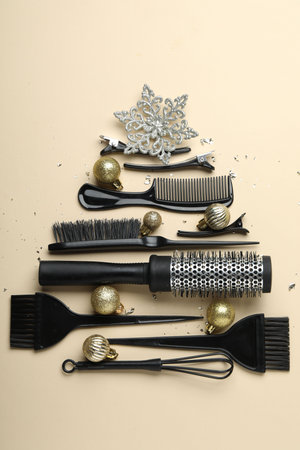 Christmas tree made of hairdresser's tools and decor on beige background, flat layの写真素材