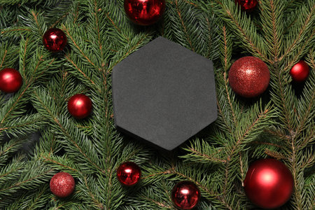 Blank card and Christmas ornaments on spruce branches, flat lay. Space for textの写真素材