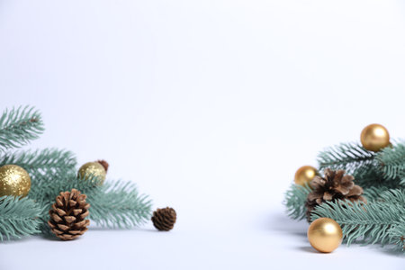 Beautiful Christmas tree branches with cones and ornaments on white background. Space for textの写真素材
