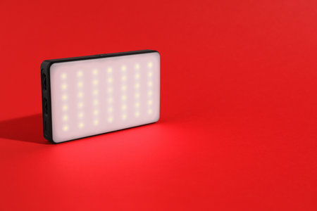 LED lamp on red background. Space for textの写真素材