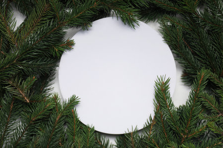 Christmas tree. Frame of spruce branches and blank card, flat lay. Space for text