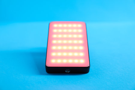 Stylish LED lamp on light blue background, closeupの写真素材