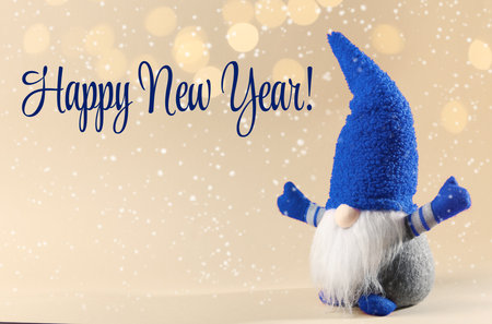 Happy New Year! Cute gnome on golden background with blurred festive lights. Christmas greeting cardの写真素材