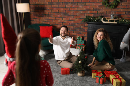 Happy family decorating room for Christmas togetherの写真素材