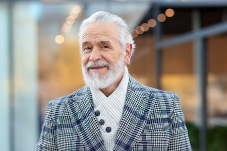 Senior man with gray hair on city streetの写真素材