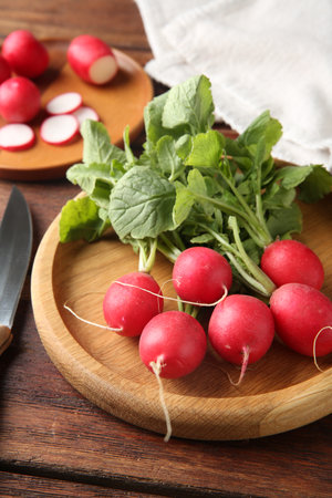 Fresh ripe radishes and knife on wooden table, closeupの写真素材