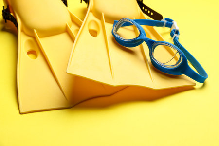 Flippers and goggles on yellow background, closeupの写真素材