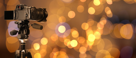 Professional camera against blurred background with bokeh lights. Banner designの写真素材