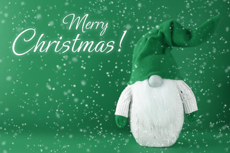 Merry Christmas! Holiday card with cute gnome and snow on green backgroundの写真素材