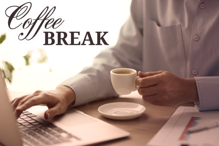 Coffee break time. Woman with cup of hot drink using laptop at desk in office, closeup