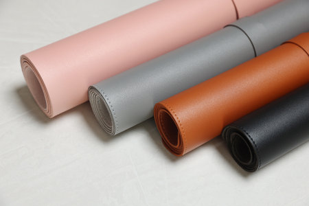 Different rolled computer mats on light gray table, closeupの写真素材