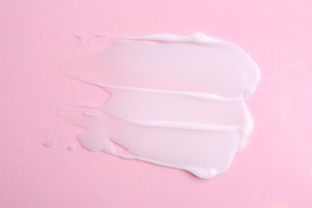 Sample of moisturizing cream on pink background, top viewの写真素材