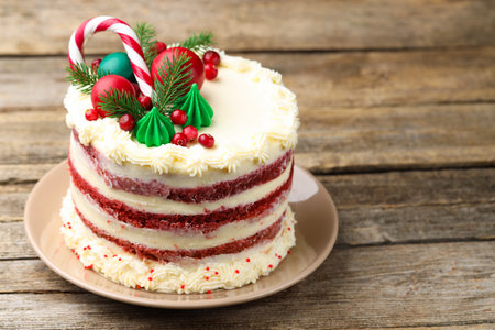 Tasty cake with Christmas decor on wooden table, closeup. Space for textの写真素材