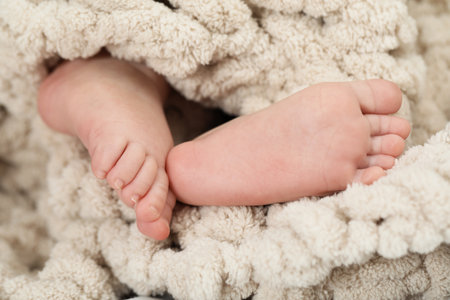 Newborn baby wrapped in soft blanket, closeupの写真素材