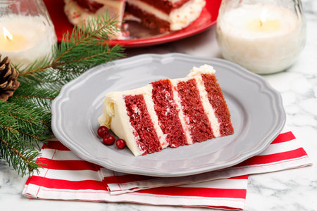 Slice of tasty cake with cranberries served on white marble table, closeup. Christmas dessert