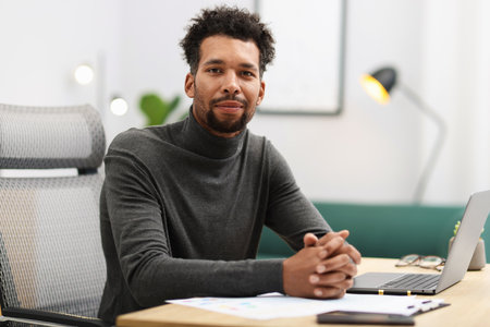Portrait of man at table in officeの写真素材