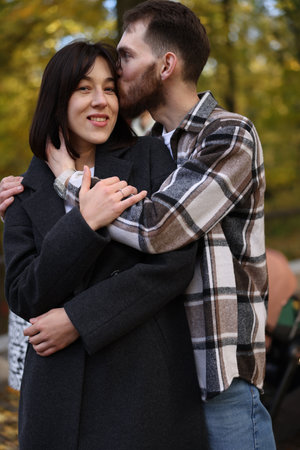 Affectionate couple enjoying time together in autumn parkの写真素材