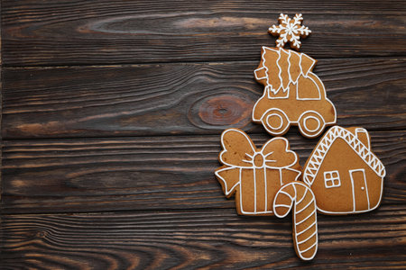 Tasty gingerbread cookies on wooden table, flat lay. Space for text