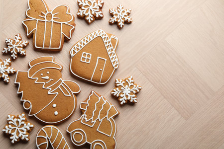 Tasty gingerbread cookies on light wooden table, flat lay. Space for textの写真素材