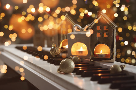 Merry Christmas and Happy Holidays. Greeting card with festive decorations on piano and bokeh lightsの写真素材