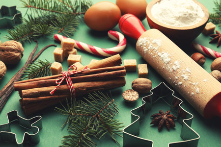 Merry Christmas and Happy Holidays greeting card with cookie cutters and spicesの写真素材