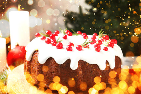 Tasty Christmas cake with red currants on table. Bokeh lightsの写真素材
