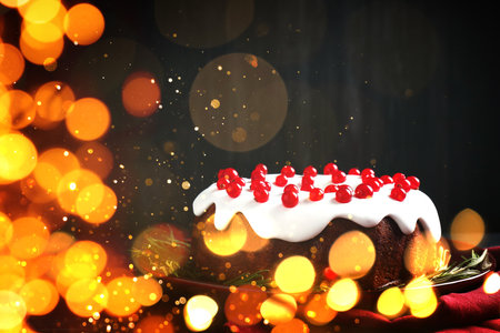 Tasty Christmas cake with red currants on table. Bokeh lightsの写真素材