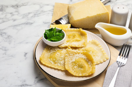 Delicious ravioli with cheese served on white marble table, closeupの写真素材