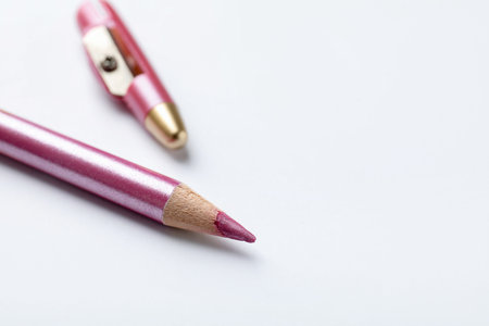 Pink eye pencil with cap on white background, closeup.の写真素材
