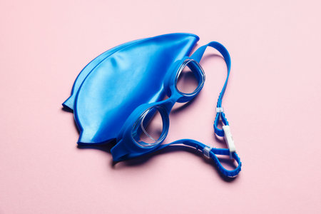 Swim cap and goggles on pink background, top viewの写真素材