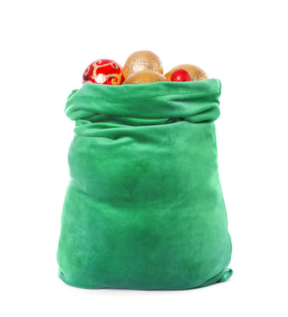 Green Santa Claus bag with shiny baubles isolated on white. Merry Christmasの写真素材