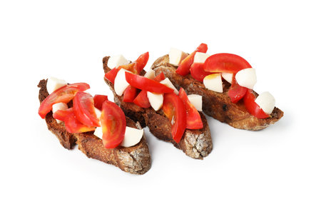 Tasty bruschettas with tomatoes and mozzarella cheese isolated on whiteの写真素材