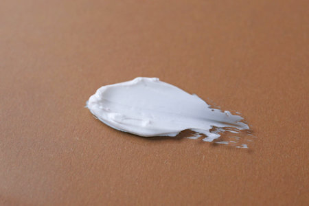 Sample of moisturizing cream on brown background, closeupの写真素材