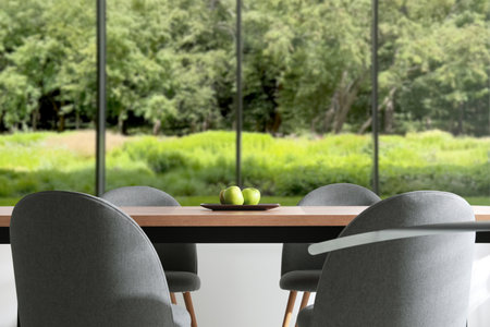 Table and chairs near large window in room. Interior designの写真素材