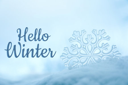 Hello winter card with snowflake in snowの写真素材